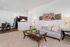 Chic modern living room with stylish decor, cozy seating, and an open kitchen, perfect for a contemporary lifestyle.
