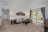 Inviting living room with elegant furnishing, large glass doors opening to a scenic view, and cozy ambiance.