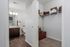 Sleek modern bathroom with stylish vanity, adjacent to a spacious walk-in closet offering ample storage and shelving.