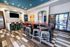 Contemporary lounge area featuring chic bar seating, vibrant artwork, and convenient snack and beverage vending machines.
