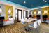 Vibrant modern office space with colorful decor, stylish furniture, and multiple workstations.