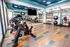 Vibrant fitness center featuring modern stationary bikes, diverse free weights, and motivational wall art.