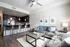 Elegant open-plan living area with a sleek modern kitchen, cozy seating space, and stylish decor, perfect for contemporary living.