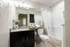 Elegant bathroom with modern fixtures, featuring a granite countertop, stylish decor, and cozy ambiance.