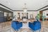 Luxurious apartment lobby featuring elegant seating, chic decor, and a stunning chandelier.
