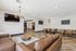 Modern lounge area with elegant leather couches, chic wooden tables, and stylish chandeliers, creating a perfect space for relaxation and social gatherings.
