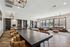 Spacious and elegant communal area with modern furniture, large windows, and stylish lighting fixtures offering a comfortable and inviting atmosphere.