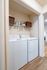 Chic laundry nook featuring modern washer and dryer with ample storage space, enhancing convenience and style.