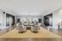 Elegant apartment lobby with stylish seating area, large windows, and warm lighting, creating a welcoming atmosphere.