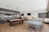 Inviting recreation room with elegant pool table, ping pong table, and stylish lounge seating, perfect for entertainment and relaxation.