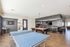 Inviting recreation room featuring a ping pong table, pool table, and cozy bar area with seating, ideal for entertainment.