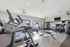 Modern fitness center with state-of-the-art equipment, large mirrors, and natural lighting.