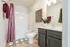 Chic bathroom with modern dark cabinetry, vibrant striped shower curtain, and elegant potted plant for a fresh look.