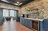 Elegant interior featuring a stylish lounge area with plush seating, luxurious wallpaper, and a modern coffee bar with sleek cabinetry.