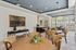 Elegant open-concept living and dining area with modern decor, stylish lighting, and abundant natural light through large windows.