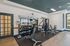 Inviting fitness center with modern gym equipment, sleek design, and ample natural light for an energizing workout experience.