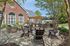 Charming outdoor patio with stylish seating and modern grills under a wooden pergola, perfect for entertaining and relaxation.