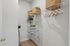Spacious walk-in closet featuring elegant wire shelving and natural storage baskets.