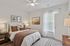 Inviting bedroom with cozy earth-tone accents, modern decor, and ample natural light highlighting elegant furnishings.