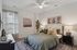 Cozy bedroom with elegant decor, featuring a plush bed, stylish bedside lamps, and serene wall art.