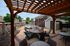 Charming outdoor patio with a cozy fire pit, ample seating, and ambient lighting, perfect for relaxation and entertaining.