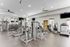Modern fitness center with state-of-the-art equipment, sleek design, and ample natural light.