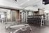 Modern fitness center with state-of-the-art exercise machines, free weights, and sleek design.