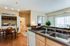 Charming apartment kitchen with modern fixtures, open dining area, and convenient in-unit laundry. Bright and inviting living space with elegant decor.
