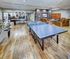 Luxurious recreation room featuring a pool table, ping pong table, and cozy lounge area with plush seating.