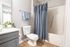 Contemporary bathroom with elegant gray accents, featuring a sleek vanity, plush towels, and a stylish shower curtain.