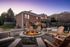 Charming outdoor seating area with a cozy fire pit at a brick apartment building, perfect for evening relaxation.