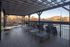 Charming outdoor deck with stylish loungers under a pergola, overlooking serene mountain and pool views.