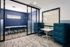 Contemporary office space with sleek blue seating, a modern conference table, and stylish decor.