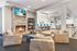 Inviting modern living room with cozy fireplace, plush seating, and a stylish open-concept kitchen area, perfect for social gatherings.
