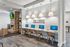 Sophisticated lounge area with cozy fireplace, modern workstations, and elegant decor, perfect for comfort and productivity.