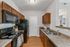 Sleek kitchen design featuring modern appliances, rich wooden cabinetry, and elegant countertops, perfect for home chefs.
