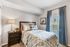 Inviting bedroom with cozy bedding, soft lighting, and elegant decor, creating a serene retreat for relaxation.