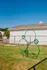 Inviting pet-friendly outdoor area featuring a playful agility hoop against a clear blue sky backdrop.