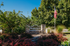 Blendon Woods luxury apartments sign amidst lush greenery and an American flag, highlighting serene and prestigious living.