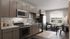 Modern open-concept living space with sleek kitchen, featuring stainless steel appliances and cozy dining area flooded with natural light.