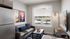 Bright and cozy apartment living room with modern decor, featuring a sleek gray sofa, stylish artworks, and a large window for natural light.