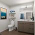 Elegant bathroom featuring modern fixtures, stylish wooden vanity, and relaxing mountain artwork.