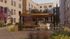 Charming outdoor courtyard with a stylish pergola, modern seating, and BBQ area surrounded by lush landscaping and vibrant apartment buildings.
