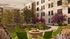 Charming apartment courtyard with vibrant landscaping, featuring a cozy fire pit surrounded by green Adirondack chairs, perfect for social gatherings.
