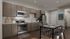 Modern kitchen with sleek cabinetry, stainless steel appliances, and an inviting dining area, perfect for entertaining.