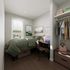 Cozy bedroom with sleek modern furnishings, featuring a comfortable bed, a well-organized workspace, and ample closet storage, perfect for a stylish and functional living space.