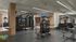 Modern fitness center equipped with state-of-the-art exercise machines, weights, and a variety of training equipment, offering a bright and motivating space for workouts.