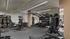Modern fitness center with state-of-the-art equipment, punching bag, and ample space for an invigorating workout experience.