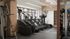 Modern fitness center with state-of-the-art treadmills, exercise equipment, and ample natural light.