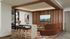 Modern living space with cozy seating, sleek wooden accents, and ambient lighting, perfect for relaxation and entertainment.